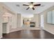 Open-concept living room with a seamless transition from the hardwood flooring to carpet and access to the kitchen at 1557 Sabatini Dr, Henderson, NV 89052
