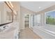 Main bathroom with double sinks, separate shower and tub, plus walk-in closet at 1557 Sabatini Dr, Henderson, NV 89052