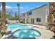 Resort-style backyard featuring a sparkling pool, spa, and lush tropical landscaping, perfect for relaxing and entertaining at 1557 Sabatini Dr, Henderson, NV 89052