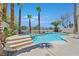 Stunning pool area with mature palm trees, concrete deck, and a built-in spa for ultimate relaxation at 1557 Sabatini Dr, Henderson, NV 89052