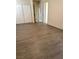 A bright room with hardwood floors, a sliding closet, and a doorway at 1936 Lawry Ave, North Las Vegas, NV 89032