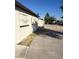Long driveway leads to the back of the beige house with security bars over windows at 1936 Lawry Ave, North Las Vegas, NV 89032