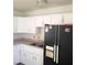 Features include white cabinets, stainless steel sink, and a black refrigerator at 1936 Lawry Ave, North Las Vegas, NV 89032