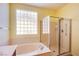 Bright bathroom featuring a glass shower, soaking tub, and a privacy window at 2131 Sandstone Cliffs Dr, Henderson, NV 89044