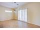 View of Living Room with tile flooring and light-filled by shuttered sliding glass doors at 2131 Sandstone Cliffs Dr, Henderson, NV 89044
