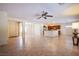 Open living room with tile floors leading to the kitchen and front entry at 2131 Sandstone Cliffs Dr, Henderson, NV 89044