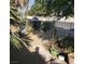 Backyard with lush greenery, a sidewalk, a garden, and a fence at 2315 Perliter Ave, North Las Vegas, NV 89030