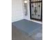 Exterior view of a home's front porch and door with a security gate at 2315 Perliter Ave, North Las Vegas, NV 89030