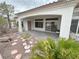 Charming back patio with stone pavers, mature landscaping, and covered area with ceiling at 2524 Banora Point Dr, Las Vegas, NV 89134