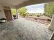 Wide, covered back patio featuring stone pavers and an open backyard with desert landscaping at 2524 Banora Point Dr, Las Vegas, NV 89134