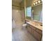 Bright bathroom with a tub and shower combination, tile floor, and single sink vanity at 2524 Banora Point Dr, Las Vegas, NV 89134