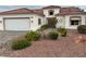 Inviting front yard with desert landscaping leads to a well-maintained home with a red tile roof and stucco exterior at 2524 Banora Point Dr, Las Vegas, NV 89134