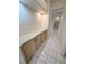 Hallway featuring tile floor and storage cabinets with light-colored countertops and black hardware at 2524 Banora Point Dr, Las Vegas, NV 89134