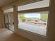 Living room featuring sliding glass doors and a large picture window that offers scenic views of the landscaped backyard at 2524 Banora Point Dr, Las Vegas, NV 89134