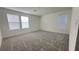 Spacious bedroom featuring soft carpet, neutral paint, and bright natural light from large windows at 2713 Abrantes Pl, Henderson, NV 89044