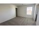 Carpeted bedroom with neutral walls and a view of tile roof outside at 2713 Abrantes Pl, Henderson, NV 89044
