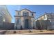 Charming two-story home with a blue door, symmetrical design, and desert landscaping at 2713 Abrantes Pl, Henderson, NV 89044