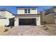 Two car garage with brick paved driveway and desert landscaping at 2713 Abrantes Pl, Henderson, NV 89044