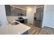 Modern kitchen with gray cabinets, quartz counters, stainless steel appliances and wood floors at 2713 Abrantes Pl, Henderson, NV 89044
