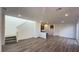 Bright, open-concept living space with wood floors, recessed lighting, and staircase at 2713 Abrantes Pl, Henderson, NV 89044