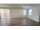 Open living space with natural light, wood floors, and sliding door to patio at 2713 Abrantes Pl, Henderson, NV 89044
