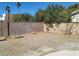 Backyard with block wall and chain link fencing, offering privacy and potential at 2784 Belcastro St, Las Vegas, NV 89117