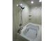 Bathroom with jacuzzi tub and shower with white marble walls and small shelves at 2784 Belcastro St, Las Vegas, NV 89117