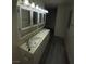 Bathroom with double sinks, white cabinets, and lots of lighting at 2784 Belcastro St, Las Vegas, NV 89117