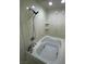 Bathroom with jacuzzi tub and shower with white marble walls and small shelves at 2784 Belcastro St, Las Vegas, NV 89117