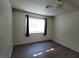 Bright bedroom features new gray flooring, a window, and modern light fixture at 2784 Belcastro St, Las Vegas, NV 89117