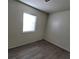 Bright bedroom features new gray flooring and a window at 2784 Belcastro St, Las Vegas, NV 89117