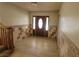 Foyer featuring a tile floor, decorative accent wall, and stylish front door at 2784 Belcastro St, Las Vegas, NV 89117