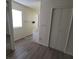Hallway leading to the bathroom features new gray flooring and closet for storage at 2784 Belcastro St, Las Vegas, NV 89117