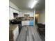 Open concept kitchen with white cabinetry, black appliances, and durable countertop at 2784 Belcastro St, Las Vegas, NV 89117
