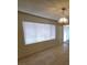 Spacious living room featuring tile floors, natural light and a classic chandelier at 2784 Belcastro St, Las Vegas, NV 89117