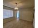 Bright living room featuring tile floors, a window, and classic chandelier at 2784 Belcastro St, Las Vegas, NV 89117