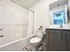 Stylish bathroom with a shower-tub combo, modern vanity, and tiled walls for easy maintenance at 302 Bay Village Pl, Henderson, NV 89011