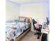 Comfortable bedroom with a wood frame bed, gaming themed bedding, and desk area at 302 Bay Village Pl, Henderson, NV 89011