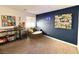 Cozy bonus room with unique wall art, a comfy chair, and a large window at 302 Bay Village Pl, Henderson, NV 89011