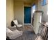 Inviting front porch with seating, a floral rug, black metal railings, and a bright blue front door at 302 Bay Village Pl, Henderson, NV 89011
