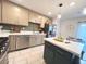 Bright kitchen features modern appliances, white countertops, an island and neutral-colored cabinets at 302 Bay Village Pl, Henderson, NV 89011