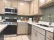 Updated kitchen with stainless steel appliances, neutral cabinets, and white countertops at 302 Bay Village Pl, Henderson, NV 89011