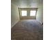 Bright carpeted bedroom featuring windows, promoting relaxation and restful nights at 3412 Townhouse Dr, Las Vegas, NV 89121
