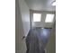 A bedroom with two large windows allowing for plenty of natural light and wood laminate flooring at 3412 Townhouse Dr, Las Vegas, NV 89121