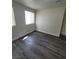 A bedroom with a window allowing for plenty of natural light and wood laminate flooring at 3412 Townhouse Dr, Las Vegas, NV 89121