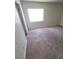 A bedroom with carpeted flooring and a large window allowing for plenty of natural light at 3412 Townhouse Dr, Las Vegas, NV 89121