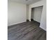 A bedroom with wood laminate flooring and a small closet at 3412 Townhouse Dr, Las Vegas, NV 89121