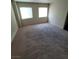 Bright carpeted bedroom featuring windows, creating a cozy and inviting atmosphere at 3412 Townhouse Dr, Las Vegas, NV 89121