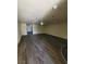 Spacious living room with modern gray wood-look floors and recessed lighting at 3412 Townhouse Dr, Las Vegas, NV 89121
