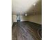Open living room featuring modern gray wood-look flooring and ample natural light at 3412 Townhouse Dr, Las Vegas, NV 89121